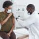 A woman sits calmly at the clinic as she gets her first dose of Xolair for allergies.