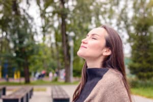 With the guidance of an allergy specialist in Texas, a woman breathes in the cool fall air